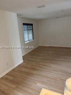 553 North West 39th Circle Boca Raton, FL 33431 - Photo 12 of 25 a view of an empty room with wooden floor and a window
