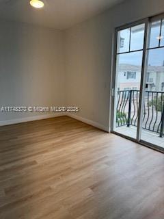 553 North West 39th Circle Boca Raton, FL 33431 - Photo 18 of 25 an empty room with wooden floor and windows