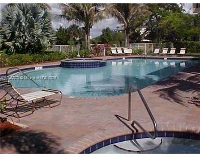 553 North West 39th Circle Boca Raton, FL 33431 - Photo 22 of 25 a view of a lake with a house and trees in the background