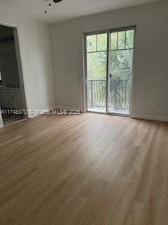 553 North West 39th Circle Boca Raton, FL 33431 - Photo 3 of 25 a view of an empty room with wooden floor and a window