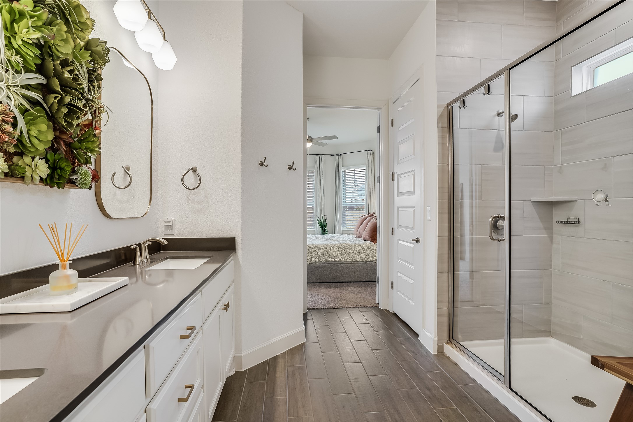 4701 Sea Salt Drive Austin, TX 78747 - Photo 16 of 29 a en suite bathroom with a granite countertop sink mirror and shower