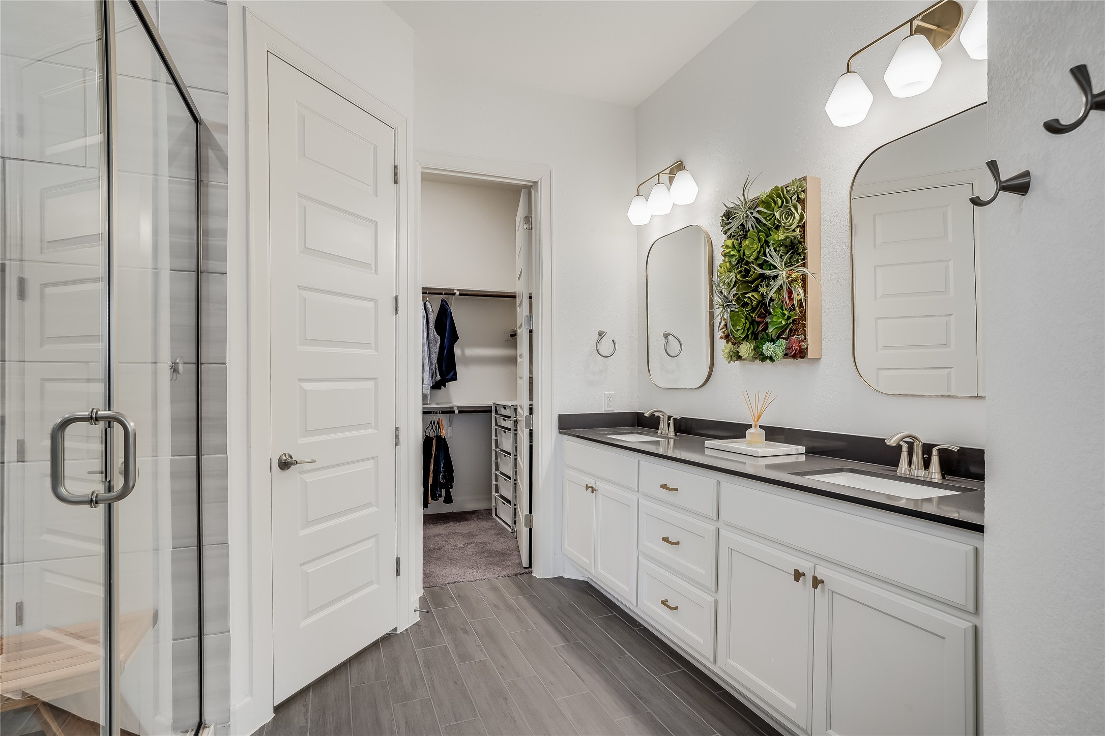 4701 Sea Salt Drive Austin, TX 78747 - Photo 17 of 29 a spacious bathroom with a double vanity sink a mirror and shower