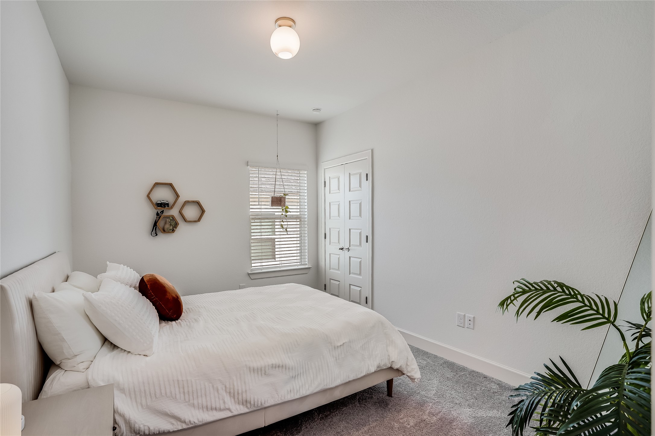 4701 Sea Salt Drive Austin, TX 78747 - Photo 18 of 29 a bedroom with a bed and a potted plant