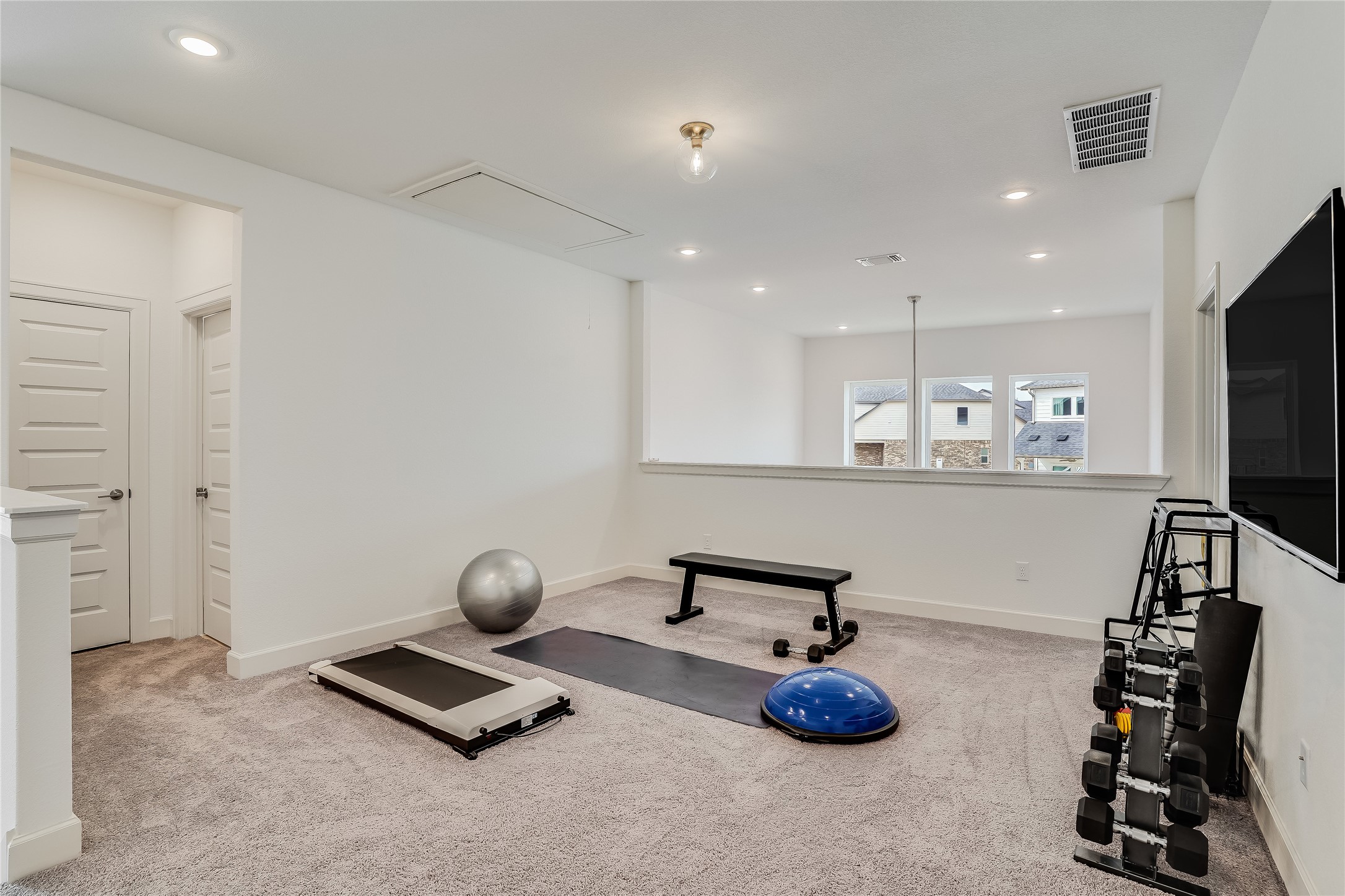 4701 Sea Salt Drive Austin, TX 78747 - Photo 20 of 29 a room with gym equipment and a flat screen tv