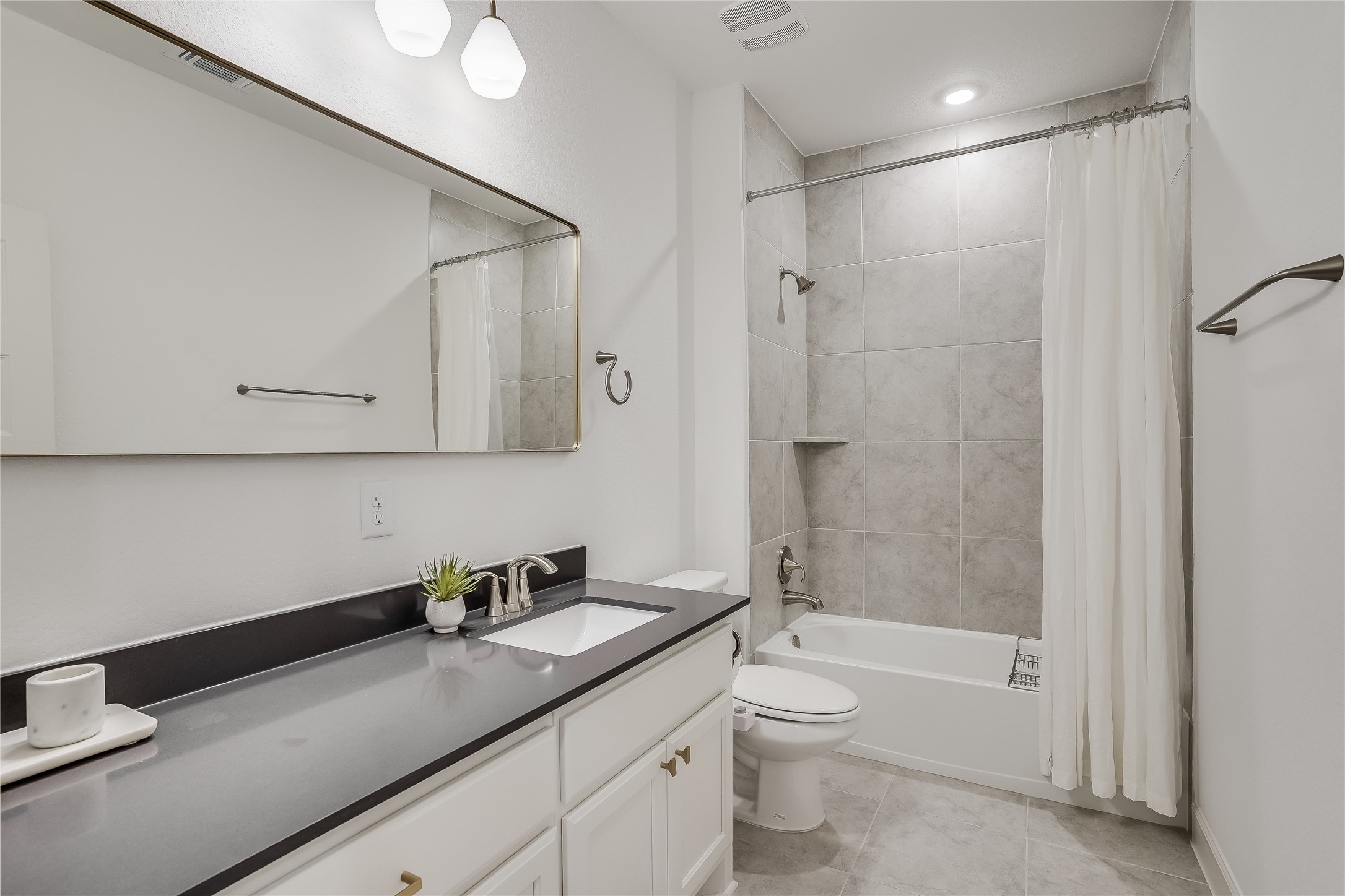 4701 Sea Salt Drive Austin, TX 78747 - Photo 24 of 29 a bathroom with a granite countertop sink a toilet and shower