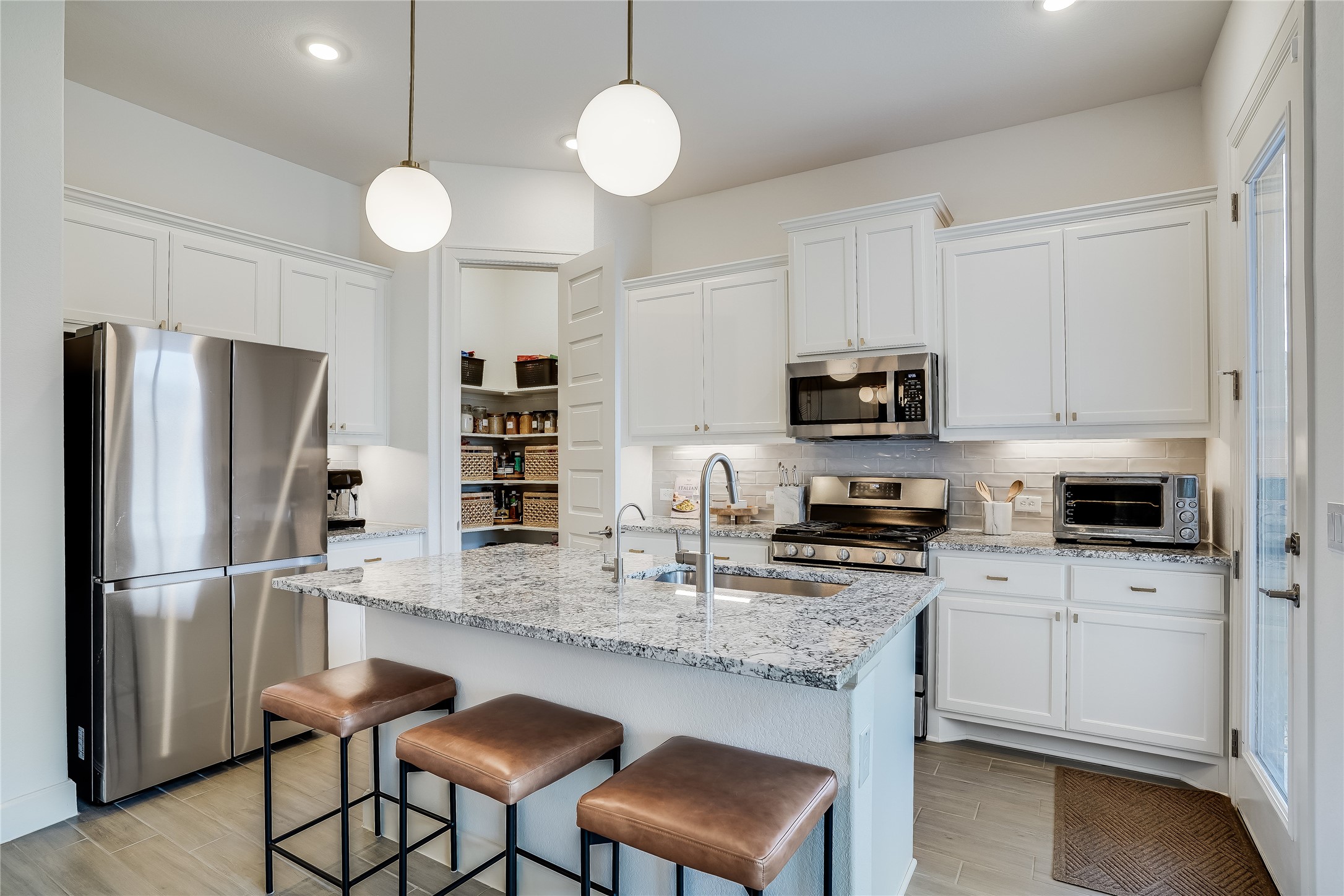4701 Sea Salt Drive Austin, TX 78747 - Photo 8 of 29 a kitchen with stainless steel appliances granite countertop a refrigerator a stove microwave and sink