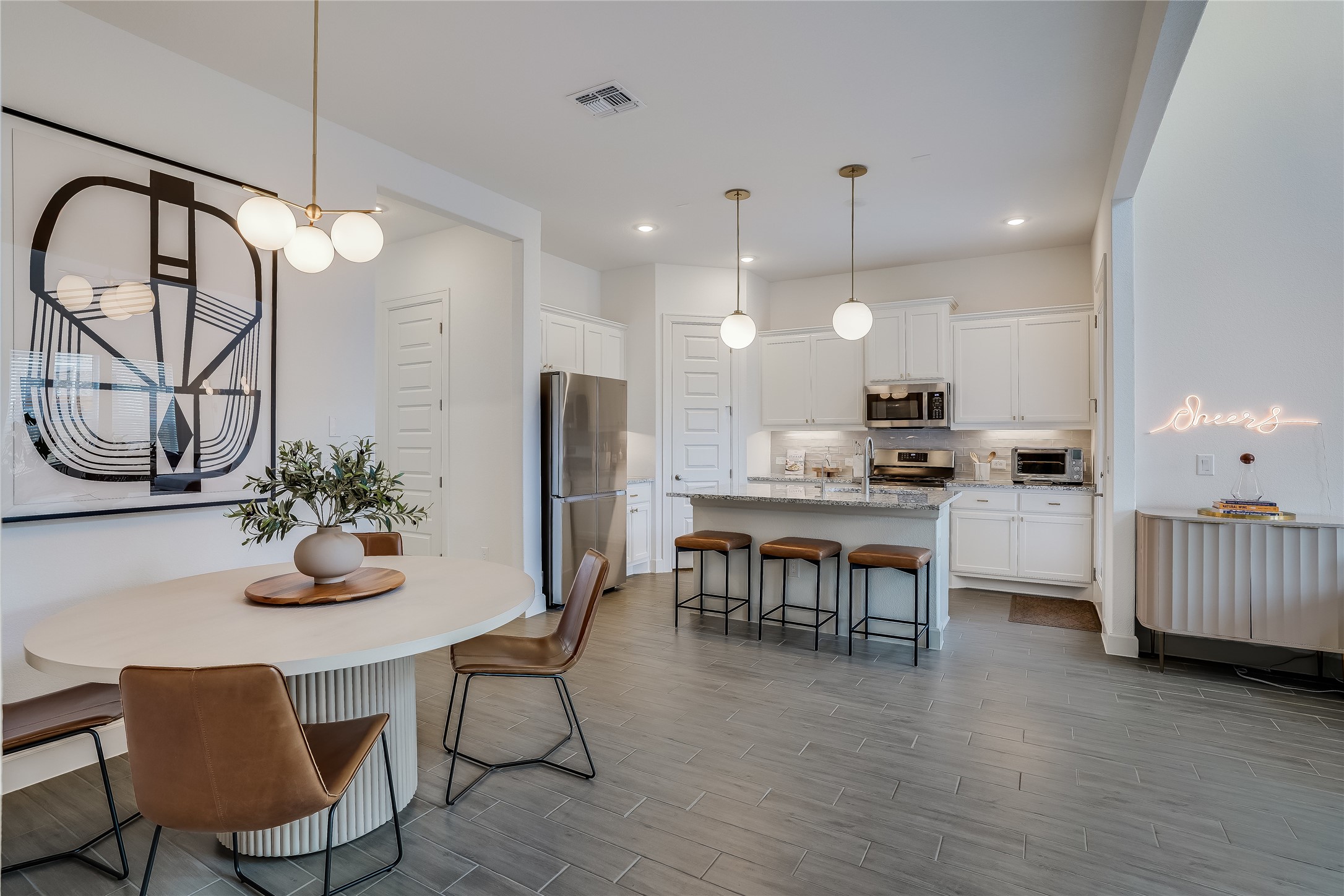 4701 Sea Salt Drive Austin, TX 78747 - Photo 9 of 29 a kitchen with stainless steel appliances kitchen island granite countertop a table chairs and a refrigerator