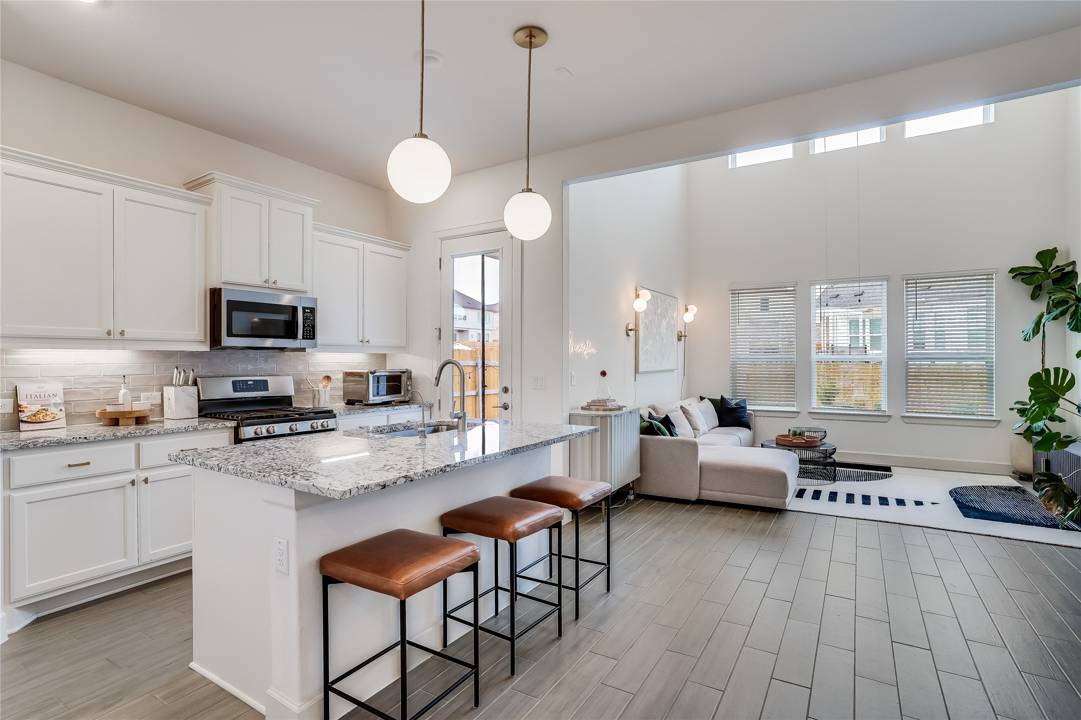 4701 Sea Salt Drive Austin, TX 78747 - Photo 10 of 29 a large kitchen with a table chairs stainless steel appliances and cabinets