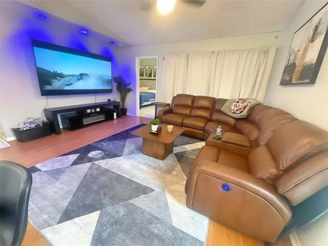 a view of a patio with a table and chairs under an umbrella