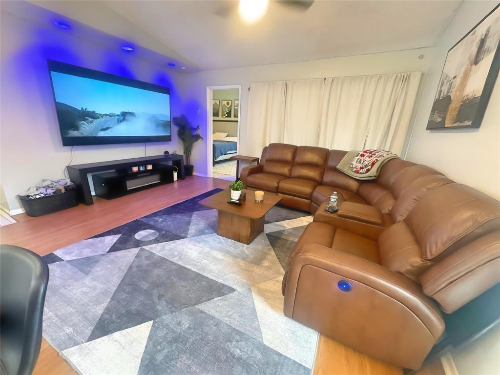 8007 Northwest 71st Court Tamarac, FL 33321 - Photo 3 of 9 a living room with furniture and a flat screen tv