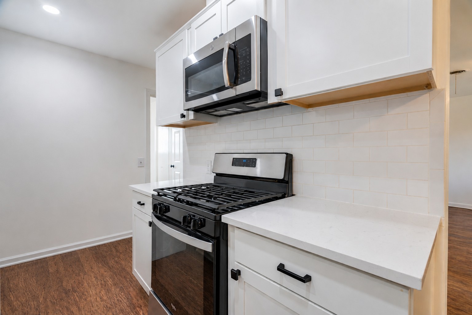1417 Braes Ridge Drive, Unit B Austin, TX 78723 - Photo 11 of 22 a kitchen with stainless steel appliances white cabinets and a stove top oven