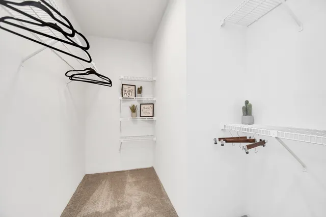 a view of a hallway with dresser