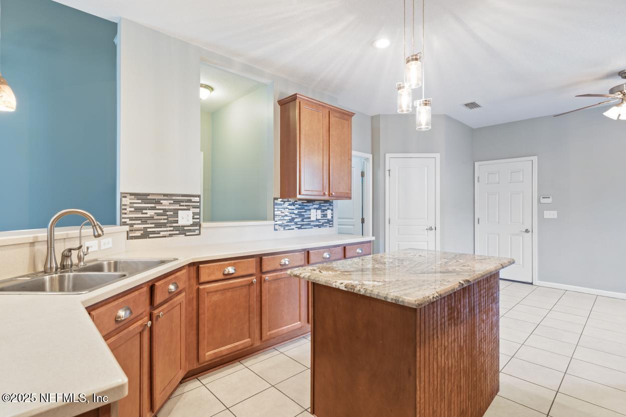700 Reflection Cove Road East Jacksonville, FL 32218 - Photo 12 of 62 a bathroom with a granite countertop sink a mirror and a bathtub
