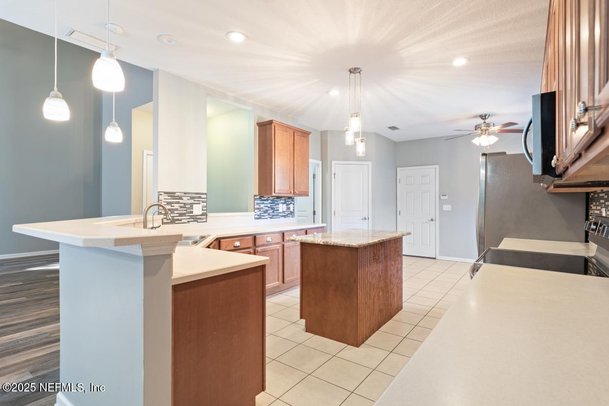 700 Reflection Cove Road East Jacksonville, FL 32218 - Photo 17 of 62 a large kitchen with stainless steel appliances a sink and a refrigerator