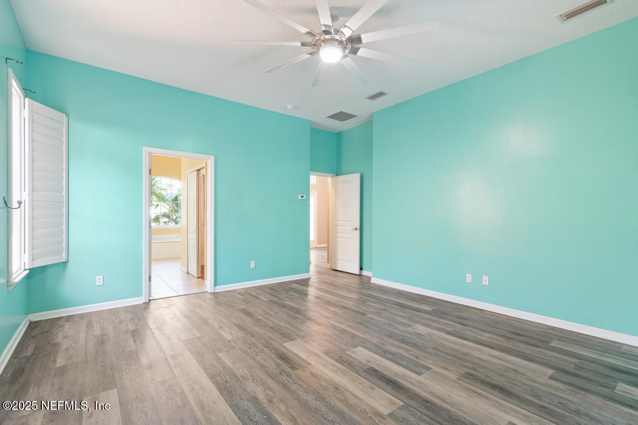 700 Reflection Cove Road East Jacksonville, FL 32218 - Photo 26 of 62 a view of an empty room with window and wooden floor