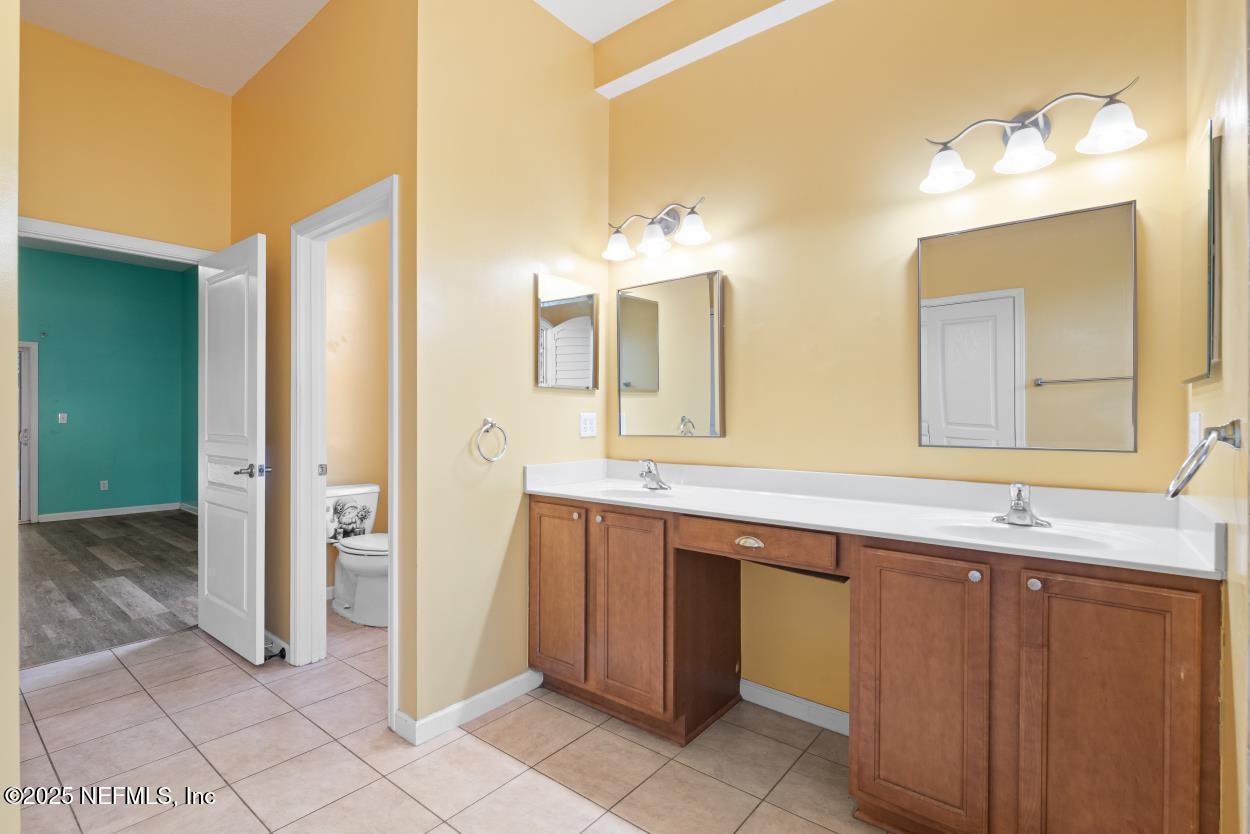 700 Reflection Cove Road East Jacksonville, FL 32218 - Photo 27 of 62 a spacious bathroom with a double vanity sink and a mirror