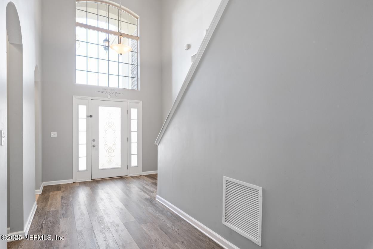 700 Reflection Cove Road East Jacksonville, FL 32218 - Photo 3 of 62 wooden floor in an empty room with a window