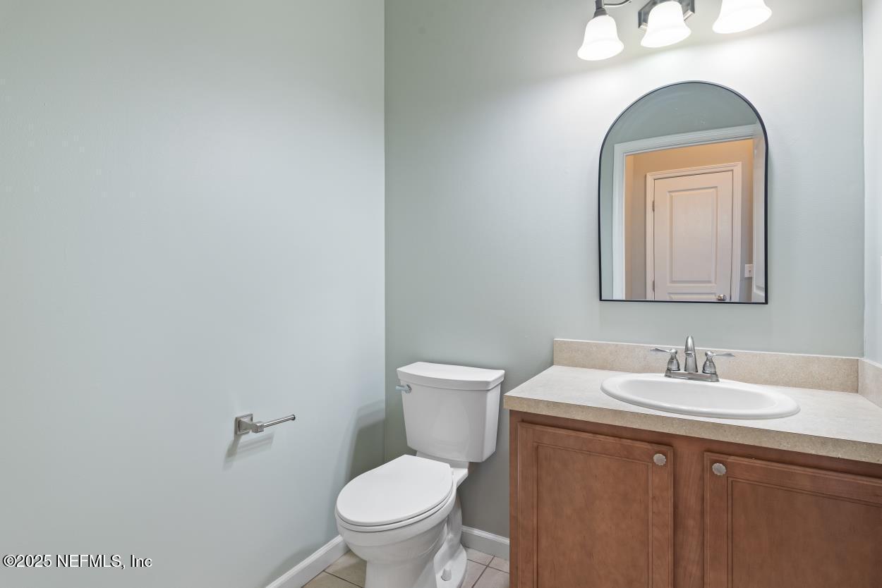 700 Reflection Cove Road East Jacksonville, FL 32218 - Photo 32 of 62 a bathroom with a toilet sink and mirror