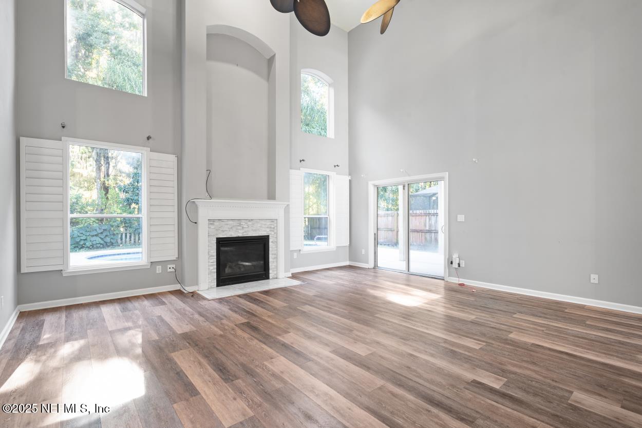 700 Reflection Cove Road East Jacksonville, FL 32218 - Photo 7 of 62 a view of a livingroom with wooden floor a fireplace and windows