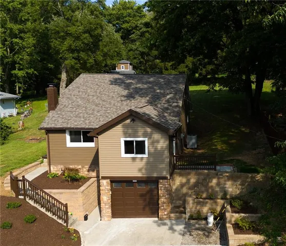 a view of house with backyard and outdoor seating