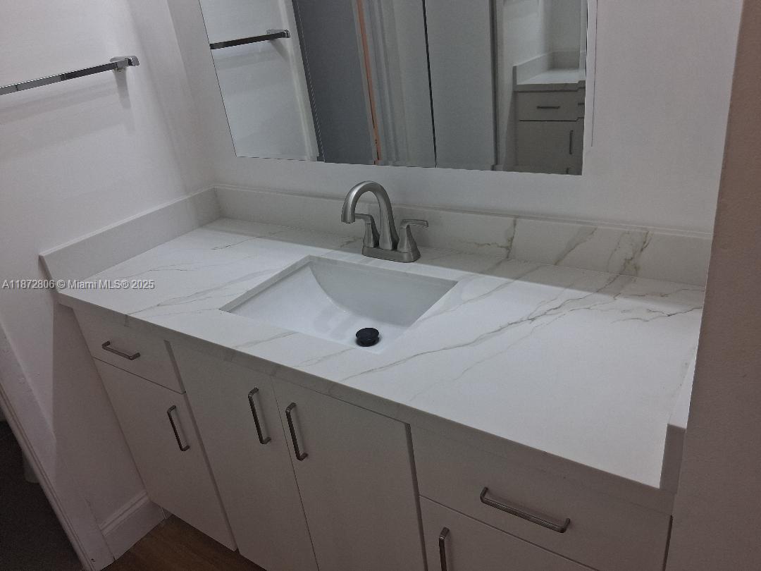 1000 St Charles Place, Unit L20 Pembroke Pines, FL 33026 - Photo 14 of 23 a bathroom with a sink and vanity