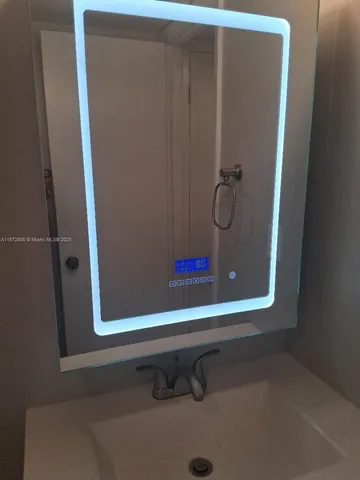 a bathroom with a shower and mirror