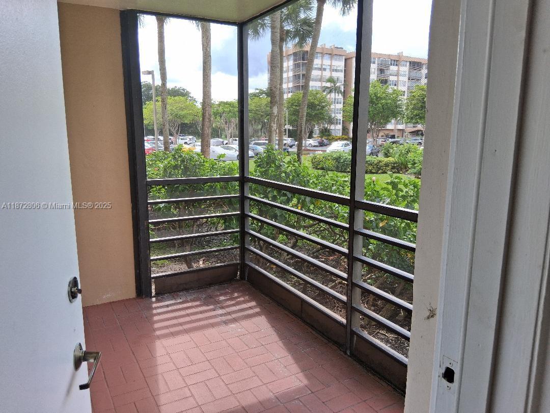 1000 St Charles Place, Unit L20 Pembroke Pines, FL 33026 - Photo 23 of 23 a room with stairs and a large window