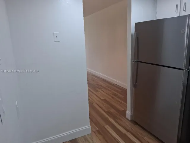 a view of walk in closet with wooden floor