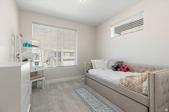839 Walker Way St. George, UT 84770 - Photo 31 of 32 Neutral wall paint, carpet flooring, a large window with blinds, and an additional transom window provide natural light