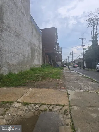 a view of a street with a big yard