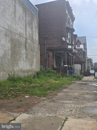 a view of a yard in front of a brick building