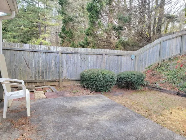 a backyard of a house with chairs and a yard
