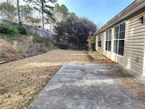 a view of backyard with large trees