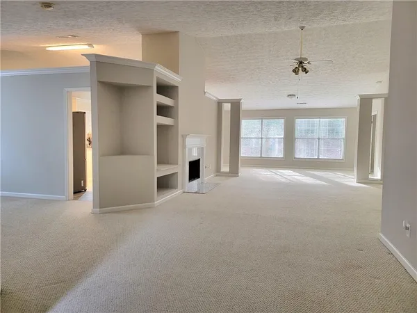 an empty room with windows and closet