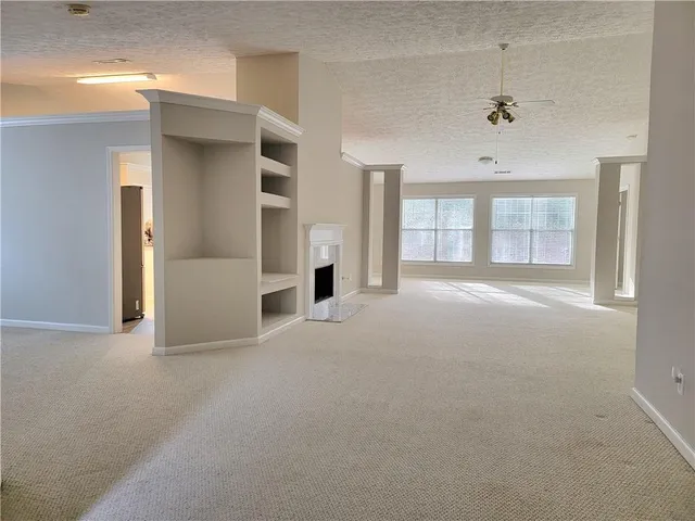 an empty room with windows and closet
