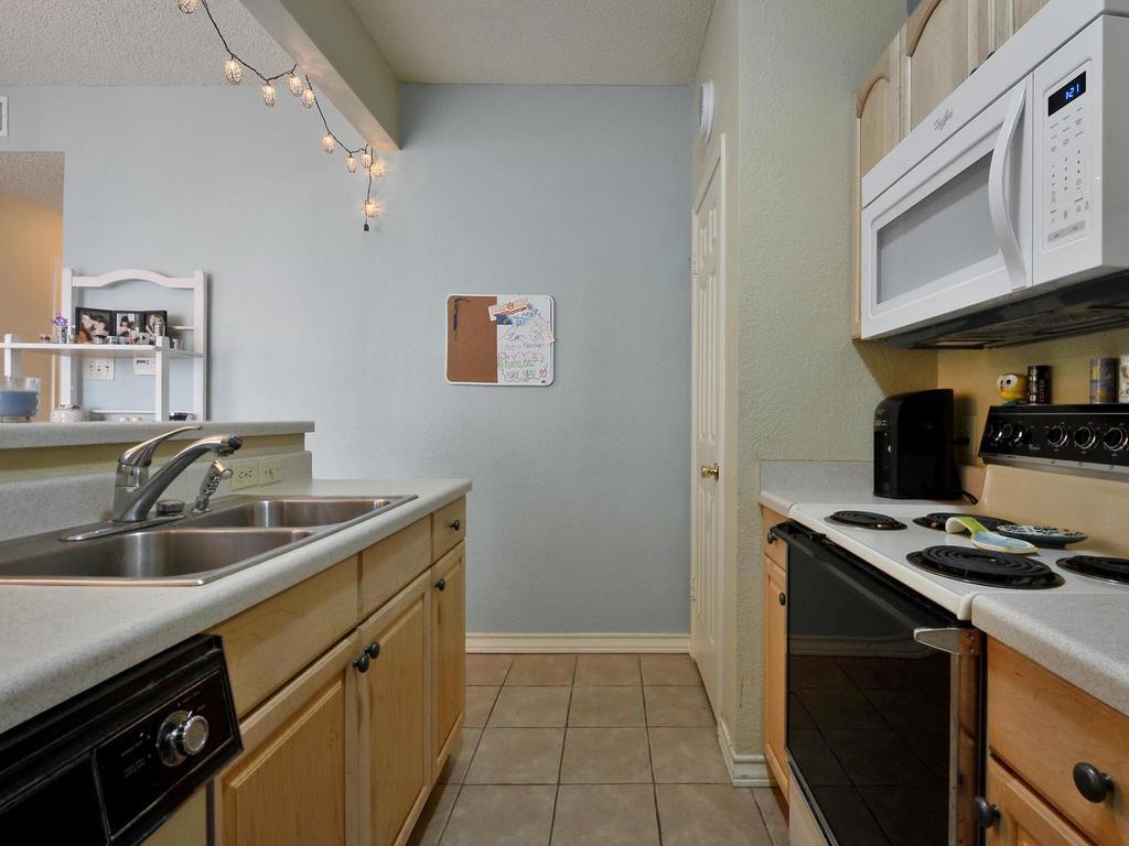 3001 Cedar Street, Unit 117 Austin, TX 78705 - Photo 14 of 20 a kitchen that has a sink and a stove