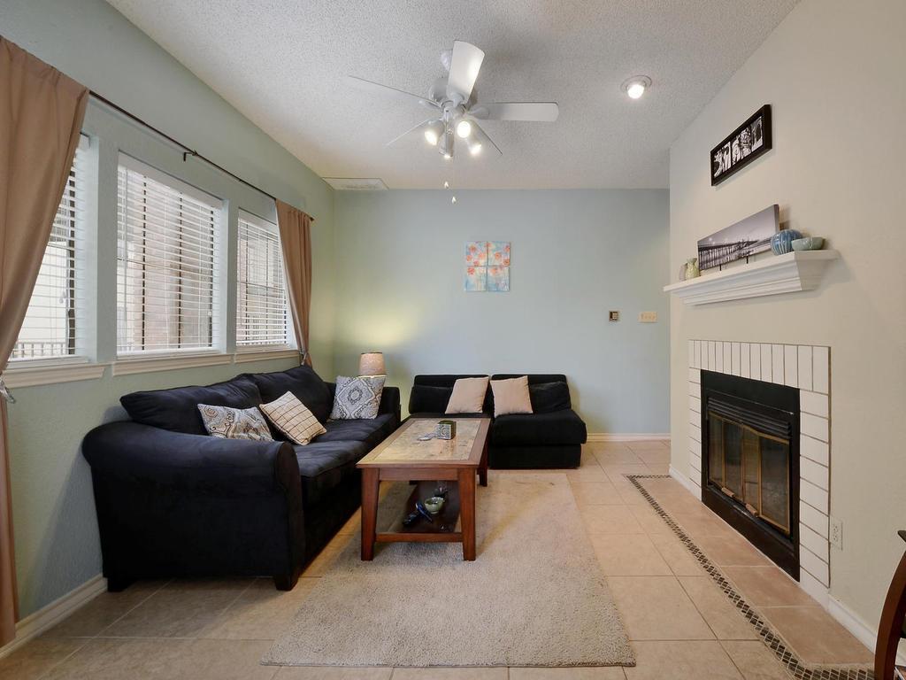 3001 Cedar Street, Unit 117 Austin, TX 78705 - Photo 2 of 20 a living room with furniture and a fireplace