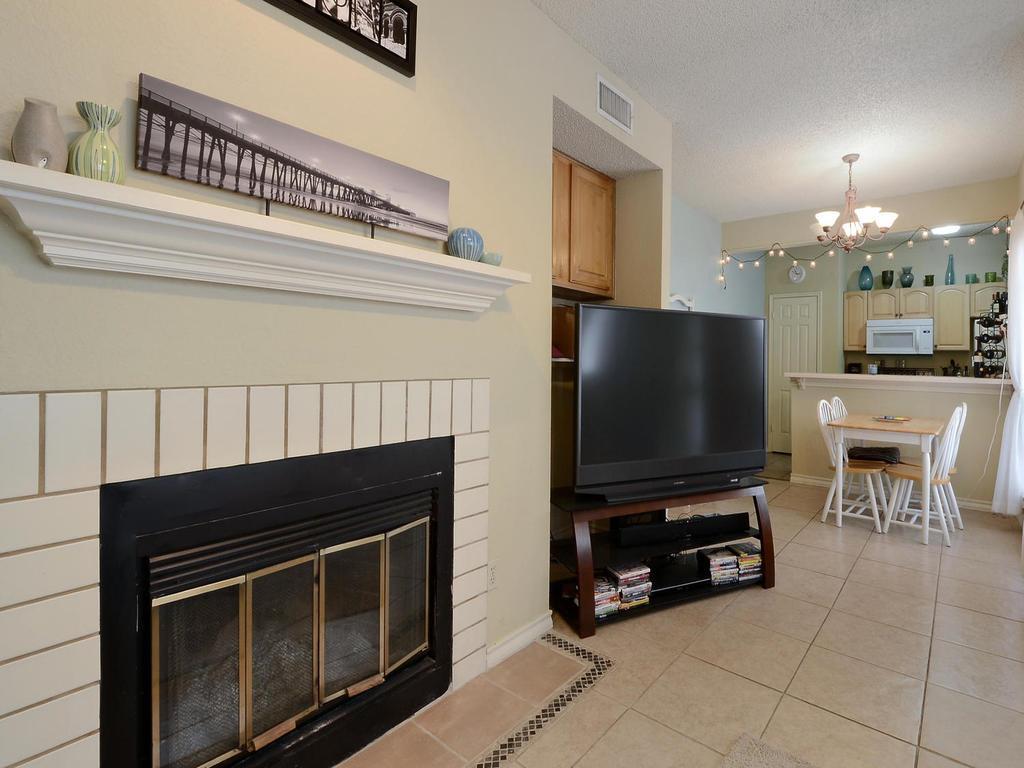 3001 Cedar Street, Unit 117 Austin, TX 78705 - Photo 5 of 20 a living room with furniture a flat screen tv and a fireplace