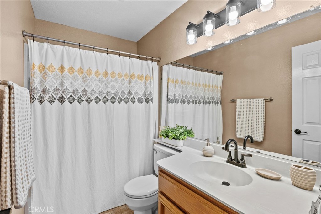 20257 Edmund Road Riverside, CA 92508 - Photo 34 of 53 a bathroom with a sink a toilet and a mirror