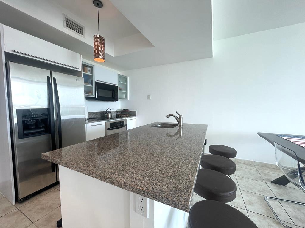 888 Biscayne Boulevard, Unit 811 Miami, FL 33132 - Photo 11 of 33 a kitchen with stainless steel appliances granite countertop a sink a stove and a refrigerator