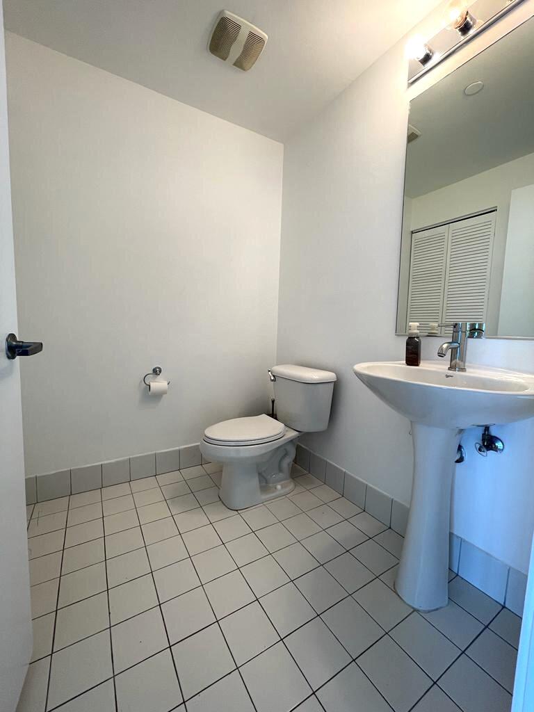 888 Biscayne Boulevard, Unit 811 Miami, FL 33132 - Photo 12 of 33 a bathroom with a sink toilet and vanity