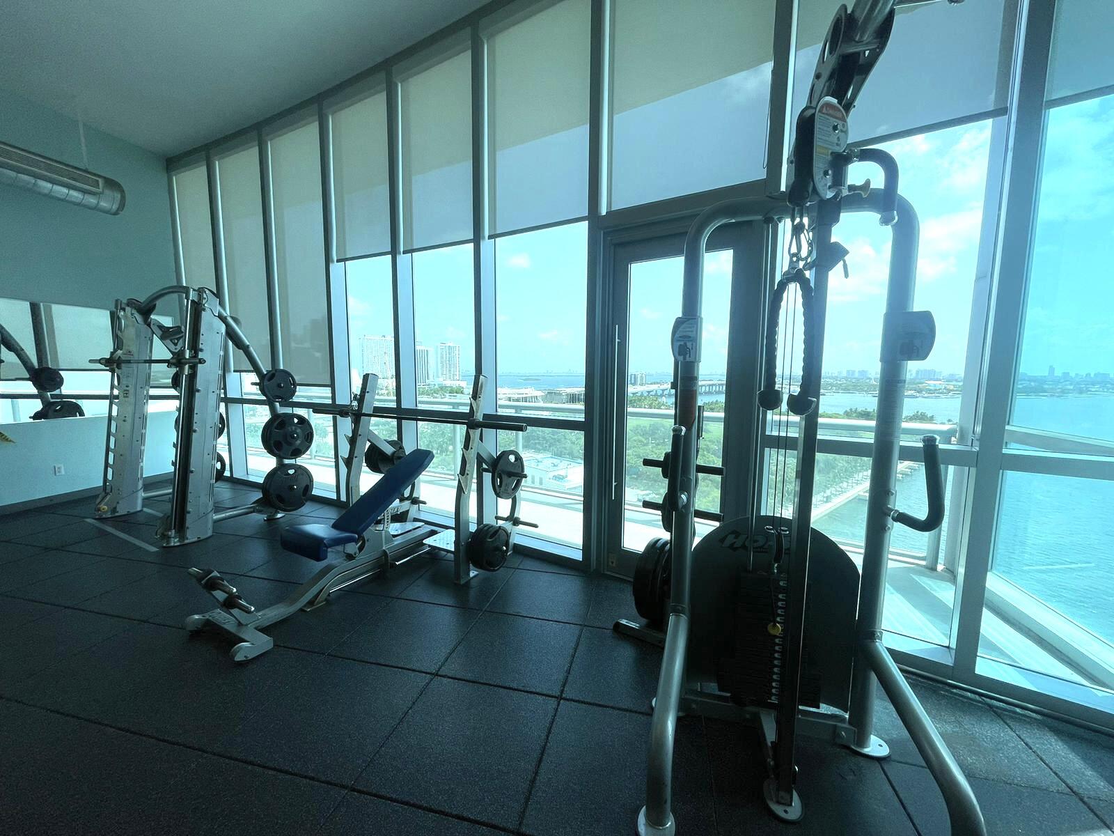 888 Biscayne Boulevard, Unit 811 Miami, FL 33132 - Photo 18 of 33 a dining room with furniture and floor to ceiling window