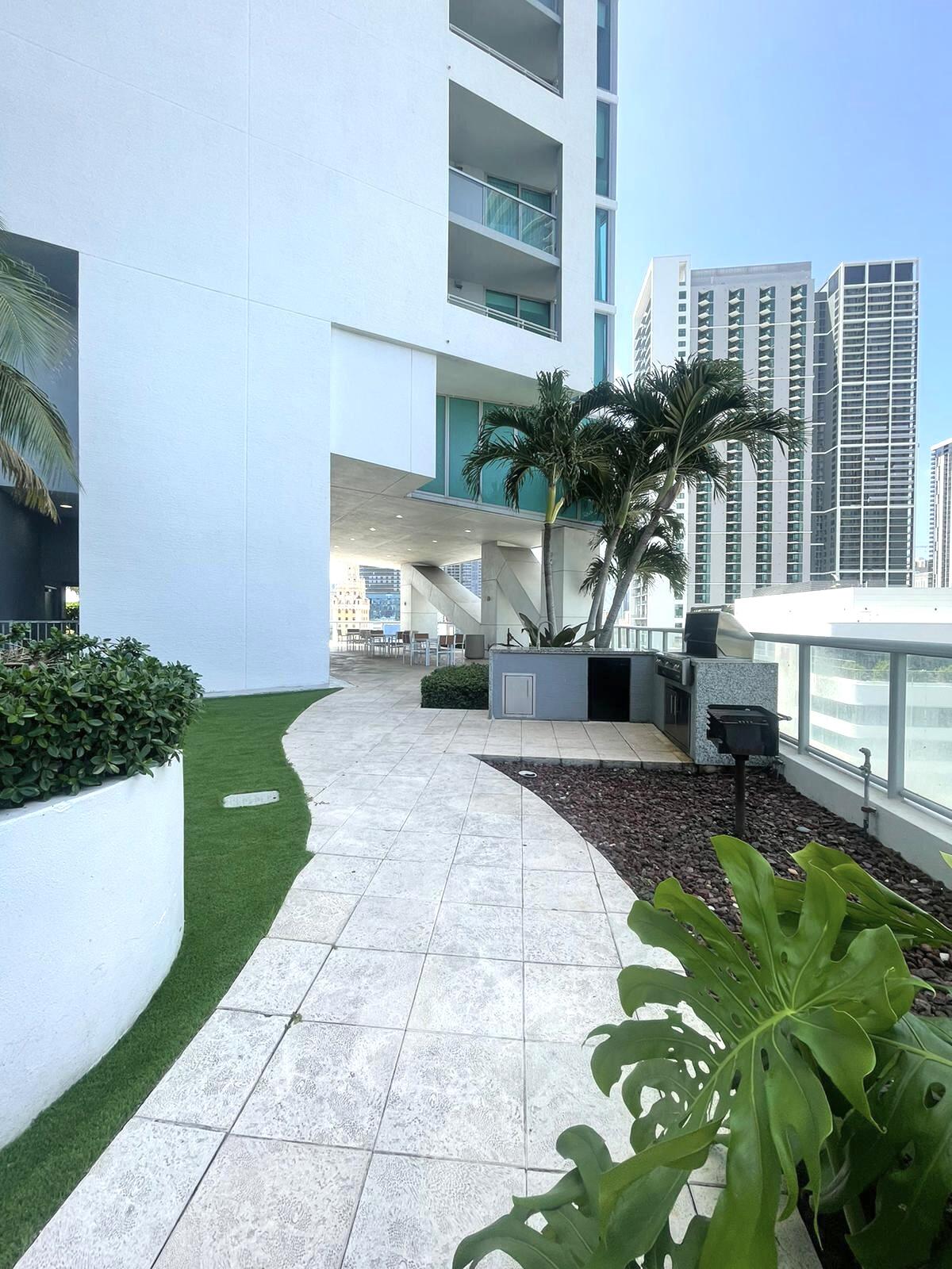 888 Biscayne Boulevard, Unit 811 Miami, FL 33132 - Photo 21 of 33 a front view of a house with a garden