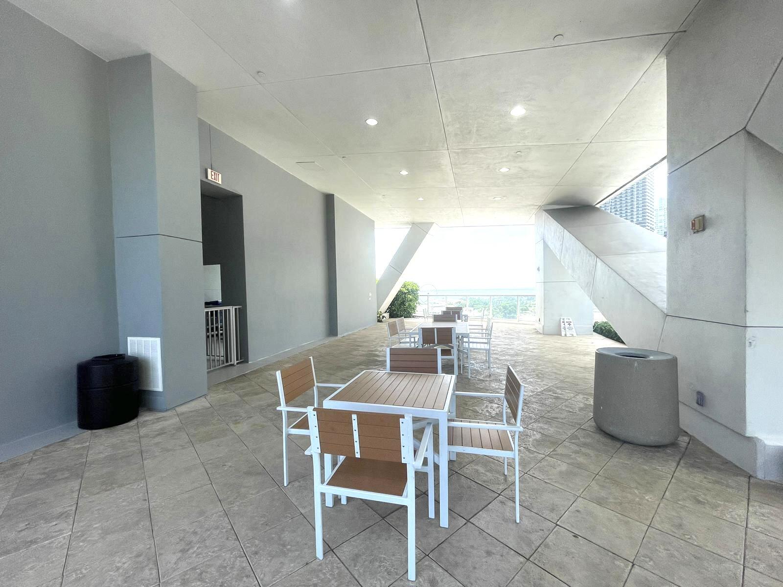 888 Biscayne Boulevard, Unit 811 Miami, FL 33132 - Photo 28 of 33 a dining room with furniture and a floor to ceiling window