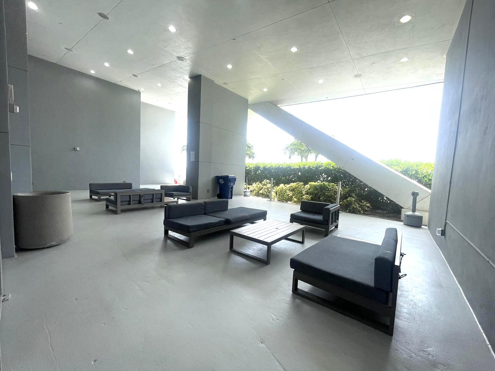 888 Biscayne Boulevard, Unit 811 Miami, FL 33132 - Photo 29 of 33 a living room with furniture and a potted plant