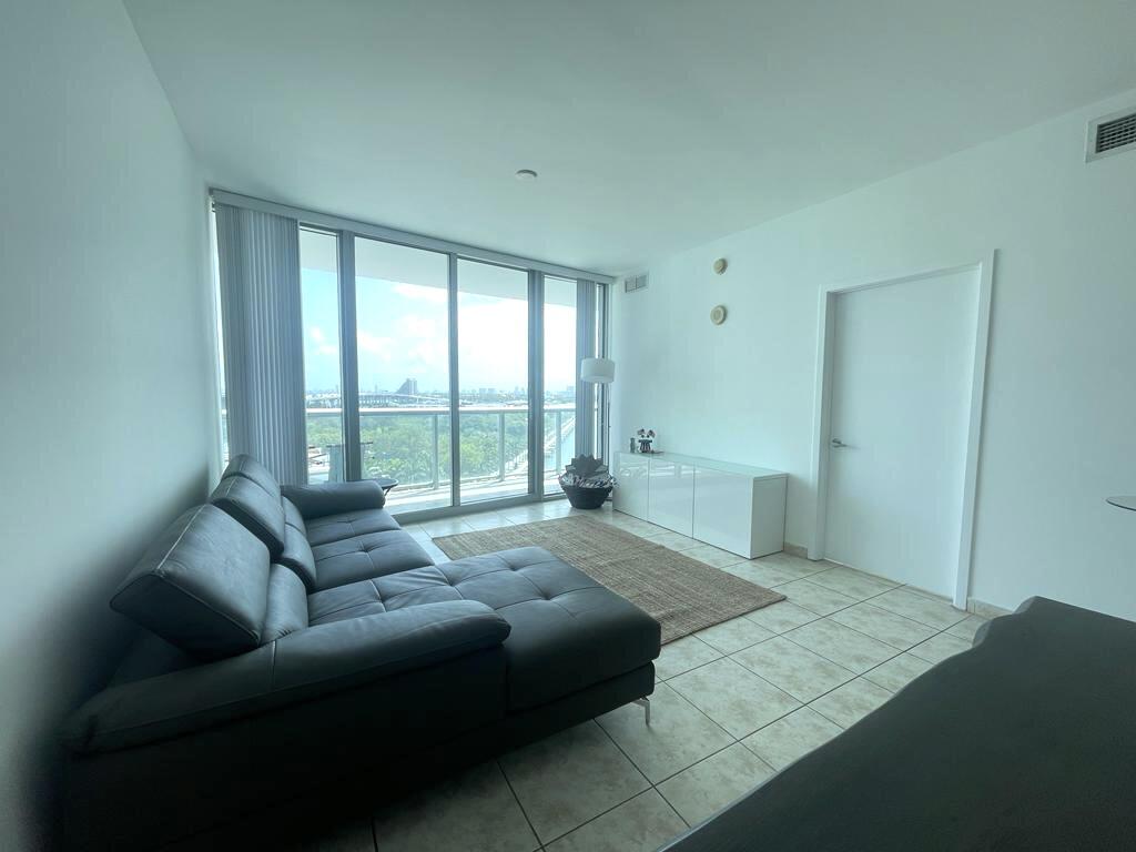 888 Biscayne Boulevard, Unit 811 Miami, FL 33132 - Photo 3 of 33 a spacious bedroom with a bed couch and two large window