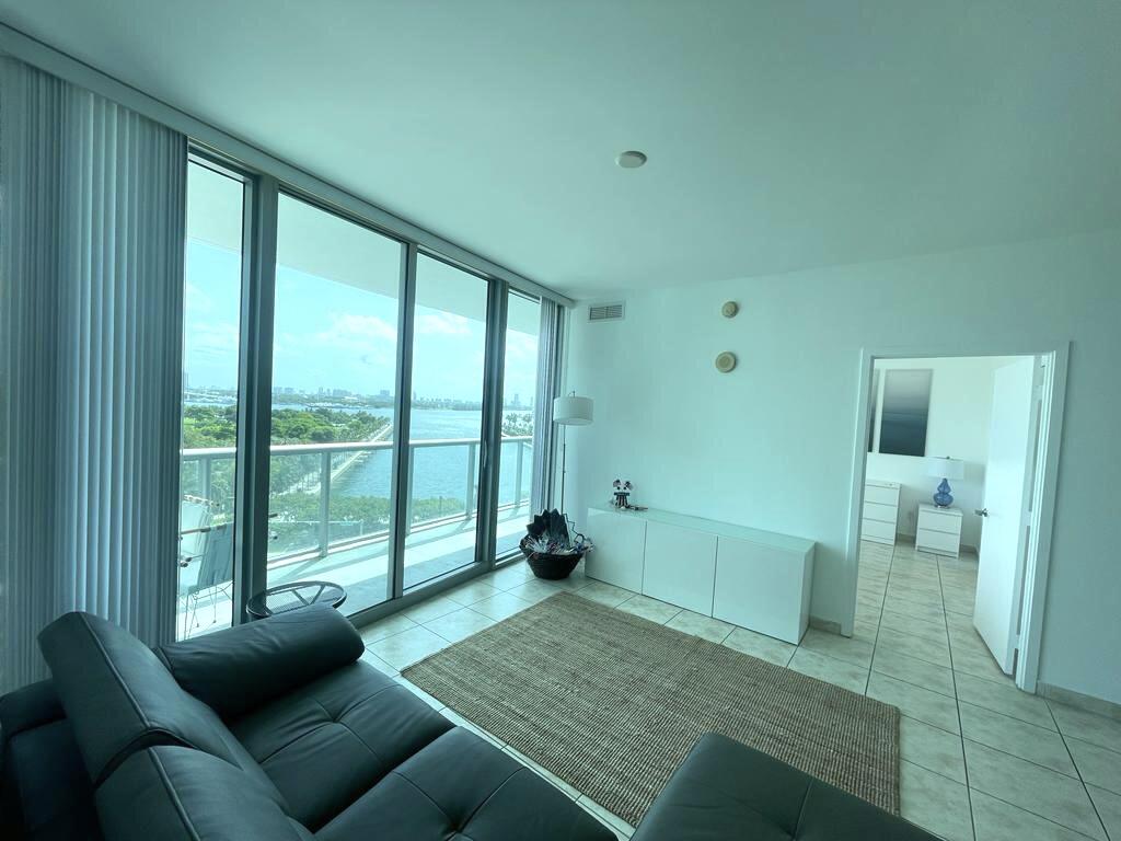 888 Biscayne Boulevard, Unit 811 Miami, FL 33132 - Photo 4 of 33 a living room with furniture and a large window