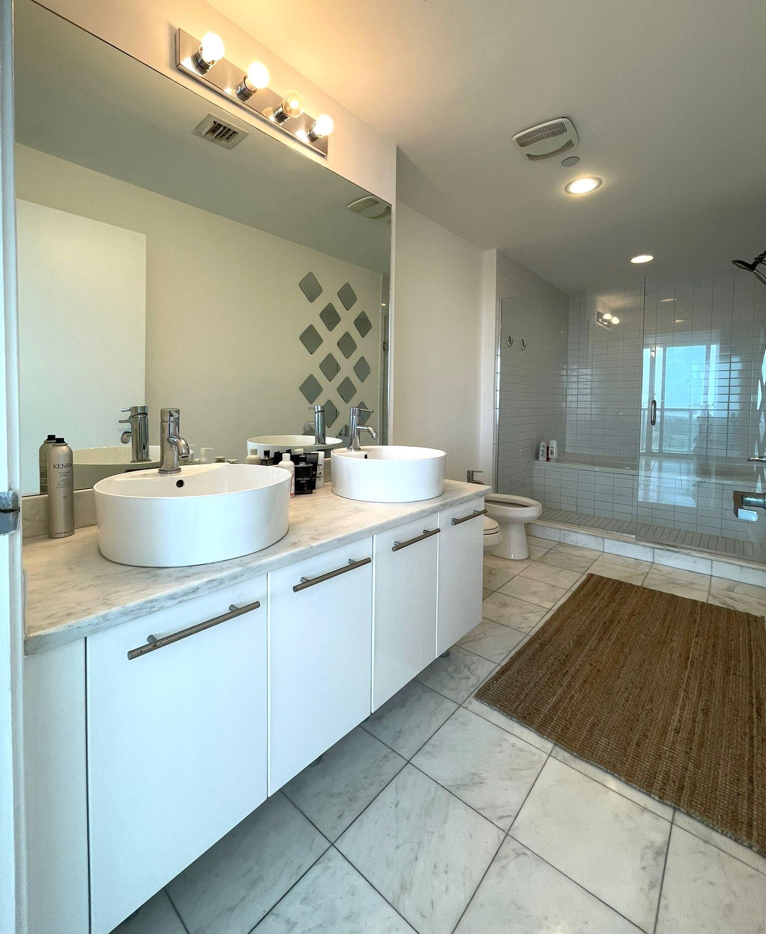 888 Biscayne Boulevard, Unit 811 Miami, FL 33132 - Photo 7 of 33 a kitchen with a sink and cabinets