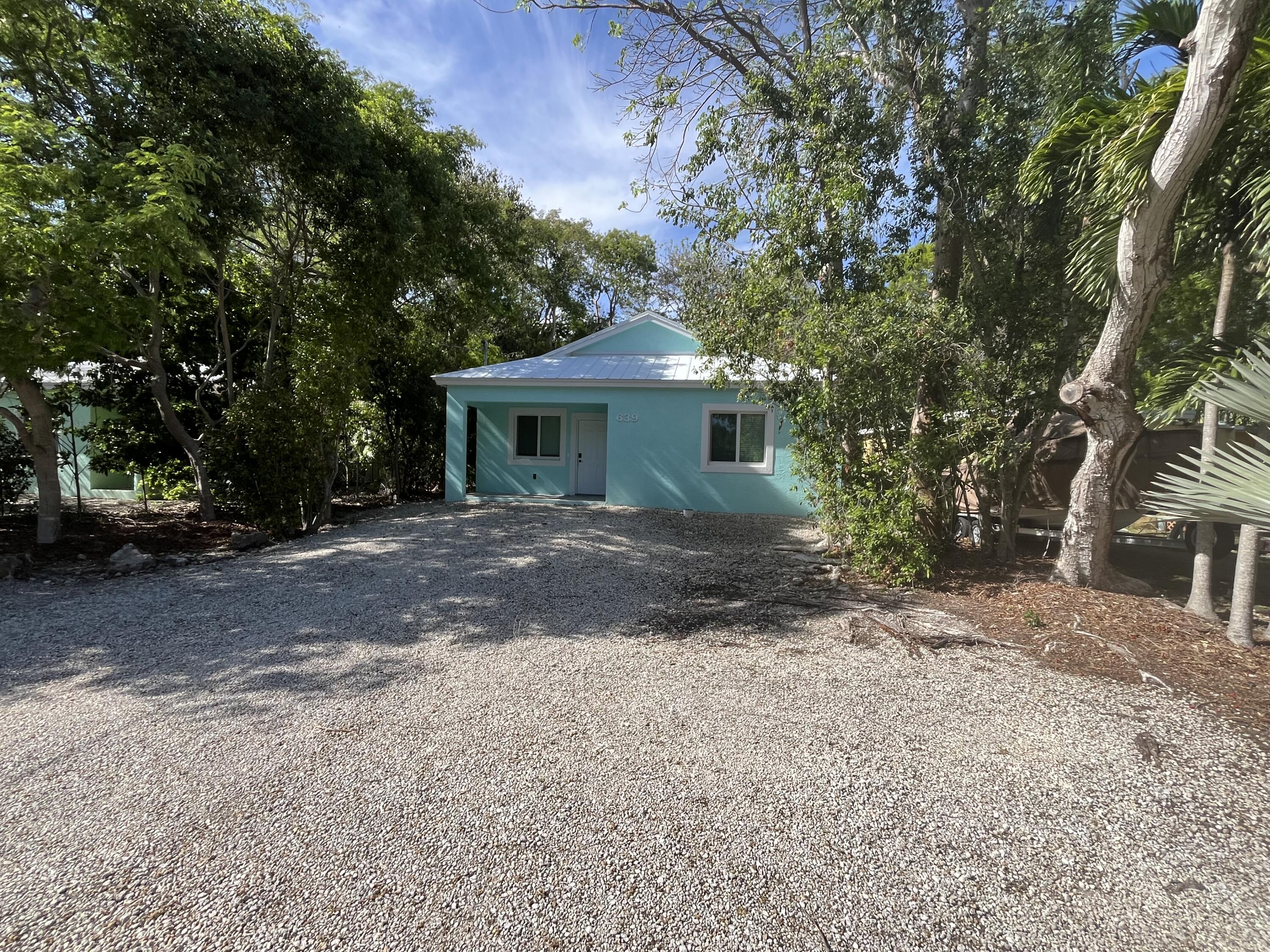 639 Cabrera Street Key Largo, FL 33037 - Photo 1 of 24 a front view of a house with a yard