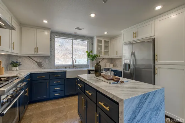 a kitchen with a stove a sink and a refrigerator